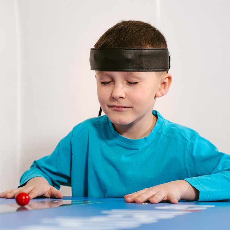 Kid focusing hard while playing Mindball Game
