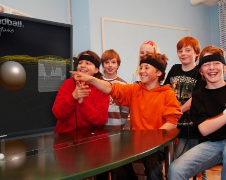 Group of happy kids playing Mindball Game